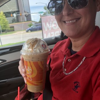 Scooter's Coffee - a smiling woman in a car - Coffee & Tea Near Me - Oklahoma City, Oklahoma