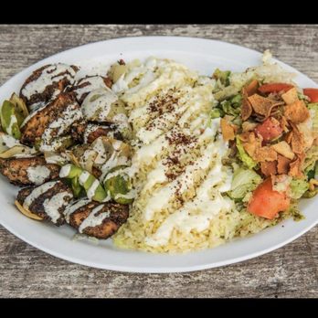 Osmow's Shawarma - a plate of food on a wooden table - Mediterranean Near Me - Dundas, Ontario Osmow's Shawarma - a plate of food on a wooden table - Mediterranean Near Me - Dundas, Ontario