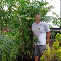 Fort Muncy Garden Center - Ricky loves helping customers, he is standing next to a selection of giant palm trees.