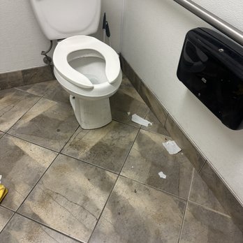 Ramona Tire - Floor with layers and layers of what looks like piss around the toilet - Auto Repair Near Me - Palm Desert, California