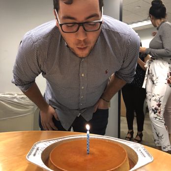 Joy Delights - a man blowing out a candle on a cake - Desserts Near Me - Miami, Florida Joy Delights - a man blowing out a candle on a cake - Desserts Near Me - Miami, Florida
