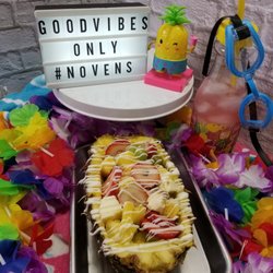 Novens Treats by V - Our juicy Pineapple Delight is a seasonal treat that is stuffed with cheesecake chunks, strawberries and grapes. It is topped with a drizzle