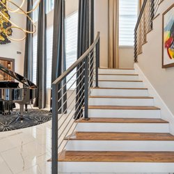 Casa Velasquez Interiors - A striking grand piano takes center stage with dramatic lighting, custom window treatments and bold black-and-gold details.