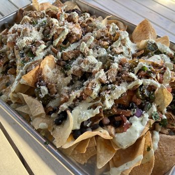 Kai Eats + Drinks - Super Nachos Pan - crazy size with Chicken - Tacos Near Me - Kailua-Kona, Hawaii Kai Eats + Drinks - Super Nachos Pan - crazy size with Chicken - Tacos Near Me - Kailua-Kona, Hawaii