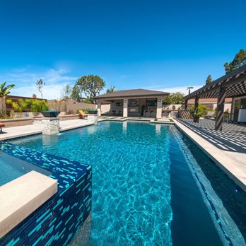 DRC Pools - This is a modern style 45′ x 22′ pool and 14 jet negative edge spa, outdoor kitchen, fireplace, and putting green. - Masonry/Concrete Near Me - Yorba Linda, California DRC Pools - This is a modern style 45′ x 22′ pool and 14 jet negative edge spa, outdoor kitchen, fireplace, and putting green. - Masonry/Concrete Near Me - Yorba Linda, California