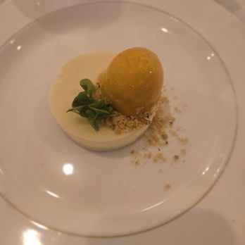 Broussard's Restaurant & Courtyard - White chocolate cheesecake with mango server and pistachios - Seafood Near Me - New Orleans, Louisiana Broussard's Restaurant & Courtyard - White chocolate cheesecake with mango server and pistachios - Seafood Near Me - New Orleans, Louisiana