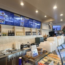 Ladera Greek Kitchen - Setup counter with menu tv screens