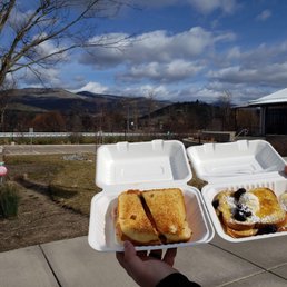 a person holding two trays of food a person holding two trays of food