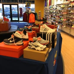 Andare Sports - another view looking towards front of store. wood area runs perimeter used to assess your shoe and for you to test out