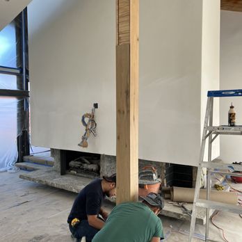 Pure Wood Flooring - two men working on a fireplace - Flooring Near Me Pure Wood Flooring - two men working on a fireplace - Flooring Near Me