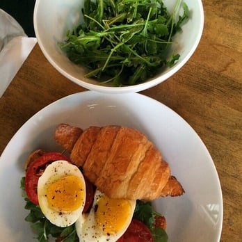 Coppa Osteria - Tomato, arugula, crispy pancetta, and soft boiled egg croissant sandwich (brunch) with arugula side salad - Italian Near Me - Houston, Texas