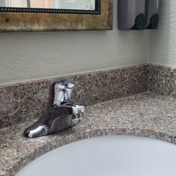 Green Country Inn - The wall mirror has a nice frame around it, not a builder grade design. Granite counter with a modern drop in sink.