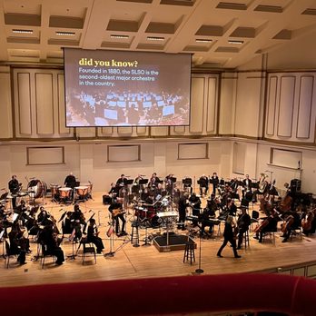Powell Symphony Hall - the orchestra performing in front of a large screen - Music Venues Near Me - Saint Louis, Missouri