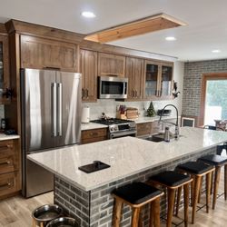 U. R. Construction - Full kitchen remodel with accent brick, quartz countertops and backsplash.   New Luxury vinyl flooring and beautiful Masterpiece cabinets.