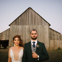 Couple posing in front of barn across the street from Spring Ranch.  Photo by http://harberphotography.com
