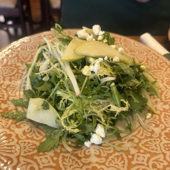 Patsy’s Pizzeria - Arugula pear salad . Yum! - A salad featuring arugula, pear slices, cheese crumbles, and possibly other greens, served on a decorative plate. - Italian Near Me - Bronxville, New York