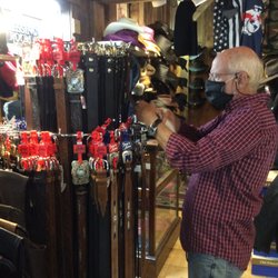 Best Bib & Tucker - Tom, shop owner, organizing new belts.