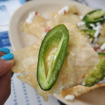 Lime - An American Cantina - a hand holding a piece of cheese and jalapeno - Mexican Near Me - Winter Park, Colorado Lime - An American Cantina - a hand holding a piece of cheese and jalapeno - Mexican Near Me - Winter Park, Colorado