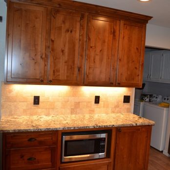 Flooring Plus - a kitchen with wood cabinets and granite countertops - Flooring Near Me - Tulsa, Oklahoma Flooring Plus - a kitchen with wood cabinets and granite countertops - Flooring Near Me - Tulsa, Oklahoma