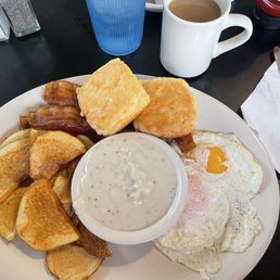 Home fries, Bacon, biscuits with gravy and two eggs over easy with coffee & water Home fries, Bacon, biscuits with gravy and two eggs over easy with coffee & water