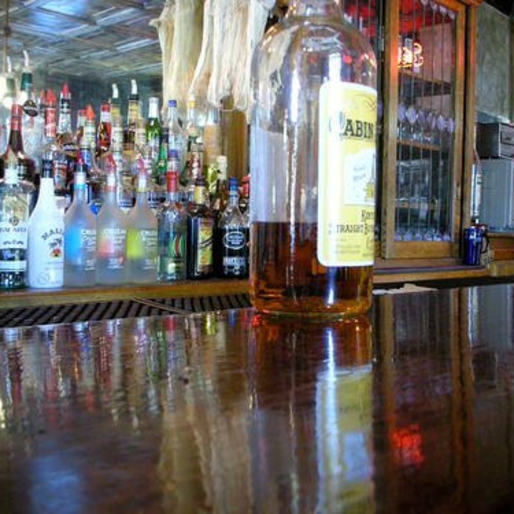 bottles of alcohol lined up on the bar bottles of alcohol lined up on the bar