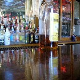 bottles of alcohol lined up on the bar