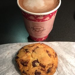 a chocolate chip cookie and a cup of coffee a chocolate chip cookie and a cup of coffee