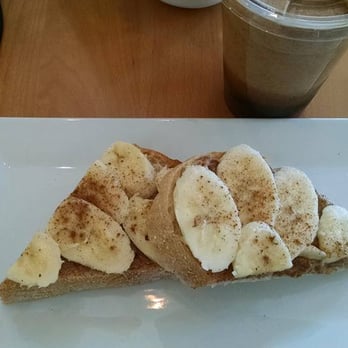 LANEY & LU - Almond Brew coffee above the plate with Sourdough toast with almond butter, bananas and cinnamon. Yummy! - Juice Bars & Smoothies Near Me - Exeter, New Hampshire