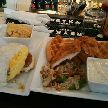Lunch. Supper! - Left: The Train wreck: Large biscuit topped with eggs sausage and gravy. Right: Chicken and waffles with hash browns and a side of gravy. - New American Near Me - Richmond, Virginia
