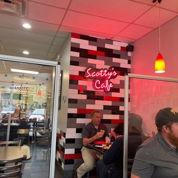Catering By Scott - a man sitting at a table eating - Delis Near Me - Columbus, Ohio Catering By Scott - a man sitting at a table eating - Delis Near Me - Columbus, Ohio