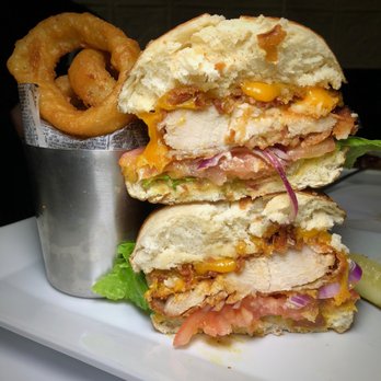 Finnegan's - Buttermilk crispy chicken sandwich with onion rings- $12.50 - Pubs Near Me - Huntington, New York