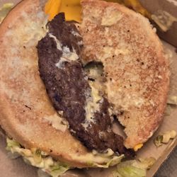 McDonald's - A broken in half nasty big mac worth a side of hardened plastic like cheese substance stuck like glue on the box.
