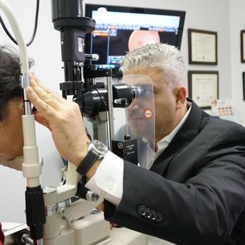 Eyes On Brickell - Dr Copty preforming 90 Diopter fundus evaluation - Eyewear & Opticians Near Me - Miami, Florida