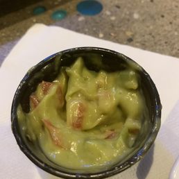 Tiny container of $4 guacamole looked like green mayo with tomatoes.
