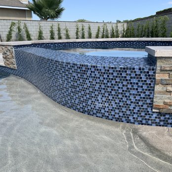 Pool Logic - Our raised spa with glass 1" mosaic and natural stone worth travertine coping. - General Contractors Near Me - San Dimas, California Pool Logic - Our raised spa with glass 1" mosaic and natural stone worth travertine coping. - General Contractors Near Me - San Dimas, California