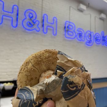 H&H Bagels - a hand holding a bagel - Bagels Near Me - New York, New York