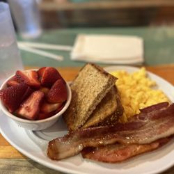 Two Chicks Café - CBD - Cafe Breakfast with scrambled eggs, toast, bacon and fruit. The fruit cup had strawberries and bananas.
