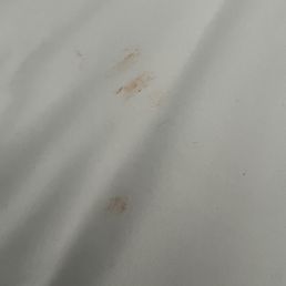 Orange Cheeto stain on sheets with someone's hair