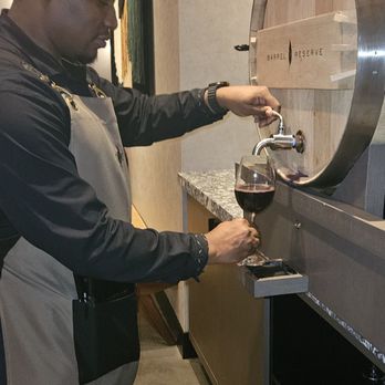 Cooper’s Hawk Winery & Restaurant - The waiter pouring wine from the reserve barrel - Seafood Near Me - Alpharetta, Georgia