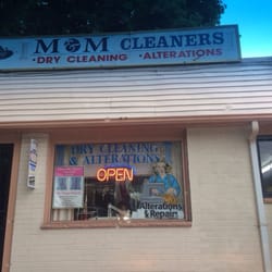 M & M Dry Cleaners & Alterations - Front with Maria in window.