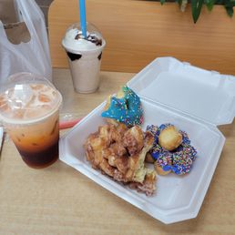 Pine cone donut, mochi donut, Thai milk tea, mocha frappe, blue iced donut with sprinkles, and extra donut holes Pine cone donut, mochi donut, Thai milk tea, mocha frappe, blue iced donut with sprinkles, and extra donut holes