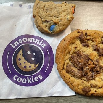 Insomnia Cookies - Classic with M&M's on the top and Chocolate Peanut Butter Cup Jumbo Deluxe Cookie on the right. - Desserts Near Me - Ames, Iowa Insomnia Cookies - Classic with M&M's on the top and Chocolate Peanut Butter Cup Jumbo Deluxe Cookie on the right. - Desserts Near Me - Ames, Iowa