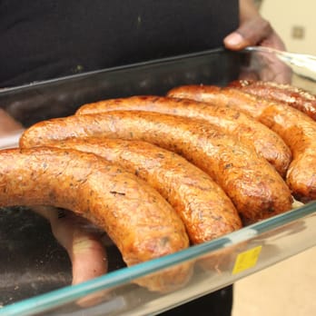 Nevaeh's Plate - a person holding a tray of sausages - Burgers Near Me - Houston, Texas Nevaeh's Plate - a person holding a tray of sausages - Burgers Near Me - Houston, Texas