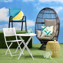 At Home - A stackable teal sling patio chair, perfect for outdoor lounging or dining with its comfortable design and vibrant color.