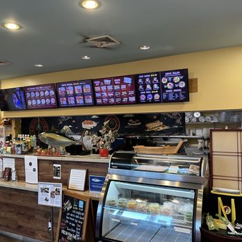 Domo Cafe Kahala - Digital neck and today's specials on the wooden easel, refrigerated case of sides and pickled items. - Sushi Bars Near Me - Honolulu, Hawaii Domo Cafe Kahala - Digital neck and today's specials on the wooden easel, refrigerated case of sides and pickled items. - Sushi Bars Near Me - Honolulu, Hawaii