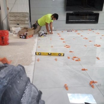 Olivares Remodel - a man working on the floor - General Contractors Near Me Olivares Remodel - a man working on the floor - General Contractors Near Me