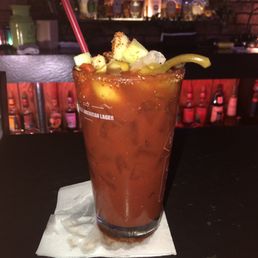 a bloody drink with a garnish on top