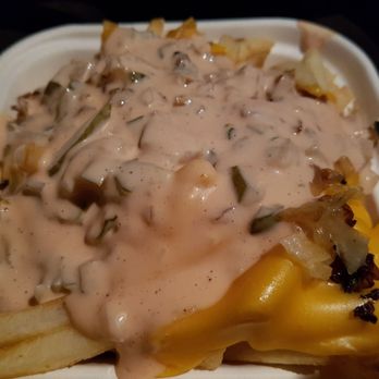 Carney's Restaurant - Train Wreck Fries small. Crispy fries topped with thousand island, cut pickles, grilled onions and melted cheese. Super yummy - Burgers Near Me - Los Angeles, California