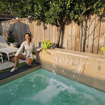 Porcelanosa - a woman sitting on the edge of a pool - Kitchen & Bath Near Me - Houston, Texas Porcelanosa - a woman sitting on the edge of a pool - Kitchen & Bath Near Me - Houston, Texas