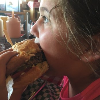Waterin' Hole Tavern - girl eating a sandwich - Bars Near Me - Fort Rock, Oregon Waterin' Hole Tavern - girl eating a sandwich - Bars Near Me - Fort Rock, Oregon